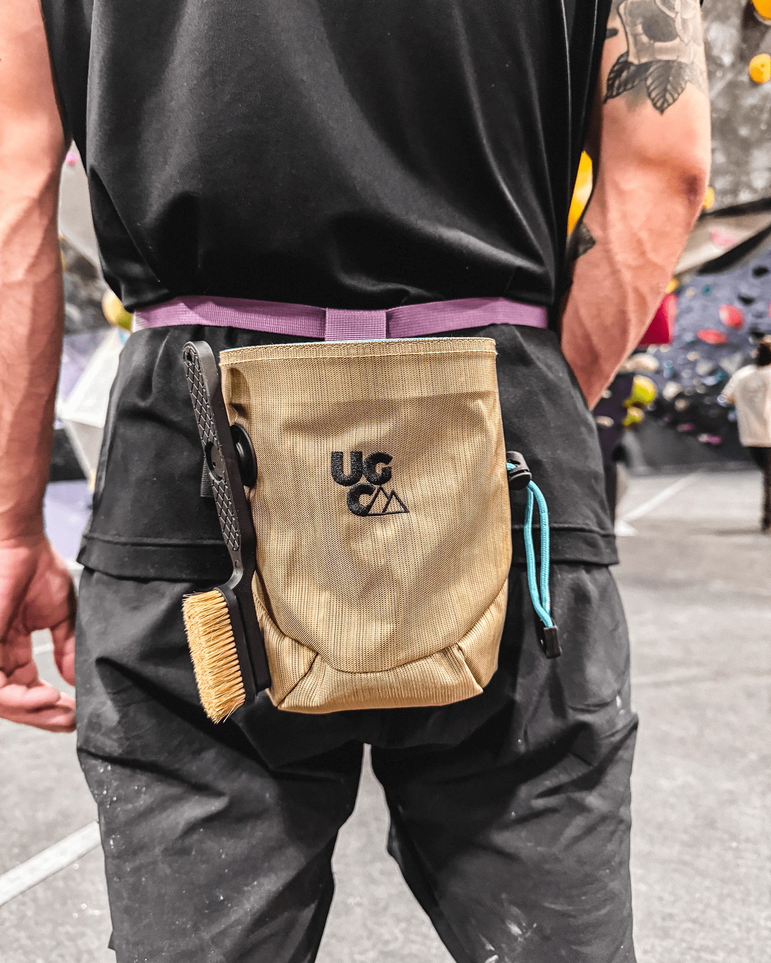 Tan and Purple Underground Climbing Chalk Bag On a Man in the Climbing Gym
